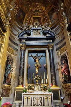 the alter of an old church with paintings on the walls and gold trimmings