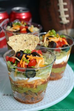 three cups filled with different types of food