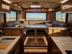 the interior of an rv with couches and tables