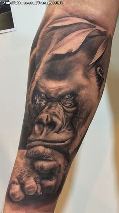 a man's arm with a gorilla tattoo on it