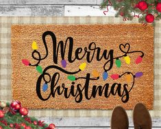 a door mat with the words merry christmas on it and someone's feet next to it