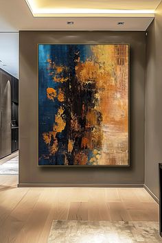 an abstract painting hangs in the middle of a room with wooden floors and walls, along with other art pieces