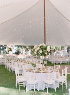 tables and chairs are set up under a tent