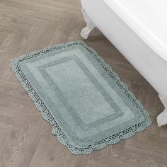 a bath tub sitting next to a rug on the floor