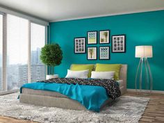 a bedroom with teal walls and pictures on the wall above the bed, along with a white rug