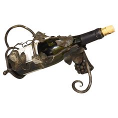 a wine bottle holder with grapes and leaves on it