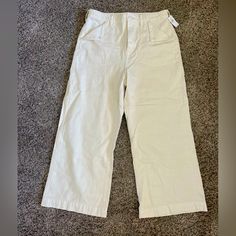 These Are Mid Waist -No Stretch- Regular Ankle Cut Pants. Off-White/Cream In Color. Front Pockets Adorn Triangular Fold Downs Held In Place With Button.Inseam Length Is 26” From Crotch To Bottom Ankle Seam. Cream Cropped Leg Workwear Bottoms, Cream Cropped Leg Bottoms For Work, Beige Wide Leg Cotton Capris, Wide Leg Beige Cotton Capris, Beige Ankle-length Cotton Capris, Casual Beige Cotton Capris, Beige Cotton Ankle-length Capris, Gap Cotton Wide Leg Bottoms, White Straight Leg Casual Capris