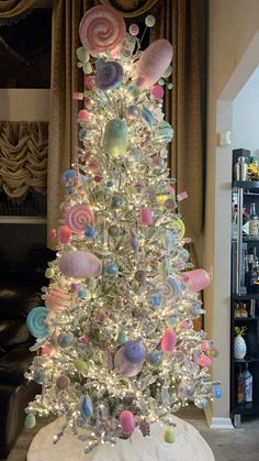 a white christmas tree decorated with lollipops and candy