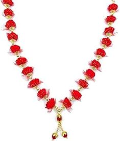 a necklace with red beads and gold accents