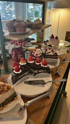 there are many different desserts on the counter at this restaurant, including cakes and pies