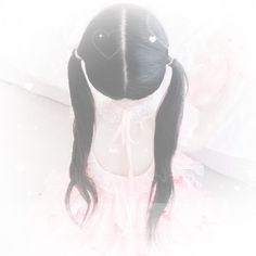 a girl with long black hair wearing a pink dress