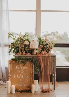 a table with candles and flowers on it next to a sign that says welcome to the wedding of amanda and alex