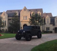 a black jeep parked in front of a large house with the words i want you on it