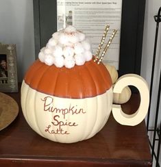 a pumpkin with cotton balls in it sitting on a table