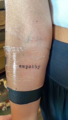 a woman's arm with the word impatily written on it