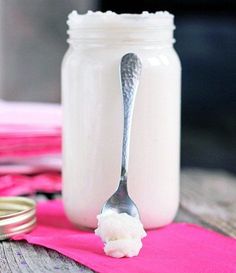 a spoon that is sitting in front of a jar with some kind of food on it