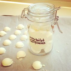 a glass jar filled with lots of white balls