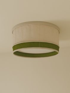 a green and white lamp hanging from the ceiling