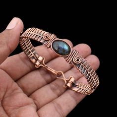 Labradorite Cuff Bracelet Copper Wire Wrapped Bangle Natural Labradorite Jewelry Gemstone Adjustable Bangle Handmade Wire Wrapped Jewelry Main Stone - Labradorite Bangle Length - 2.50 - 2.75" Inches (Adjustable) Bangle Width  -  0.50 Inches Metal                  -  Copper Copper Has Been Used For Jewelry Making For Thousands Of Years, Dating Back To Ancient Civilizations Such As The Egyptians, Romans, And Aztecs. Copper Was Valued For Its Beauty, Versatility, And Durability, And Was Often Used Artisan Labradorite Bracelets For Gifts, Adjustable Labradorite Bracelet With Unique Style, Handmade Labradorite Artisan Bracelets, Handmade Artisan Labradorite Bracelets, Handmade Labradorite Bohemian Bracelets, Handmade Labradorite Bangle Jewelry, Unique Labradorite Bangle Jewelry, Hand Wrapped Labradorite Bracelets As Gift, Adjustable Labradorite Bangle Bracelet