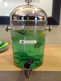 a large pot filled with green liquid sitting on top of a counter