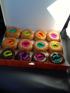 a box filled with lots of donuts covered in frosting