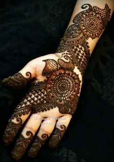 henna tattoo on the palm of someone's hand