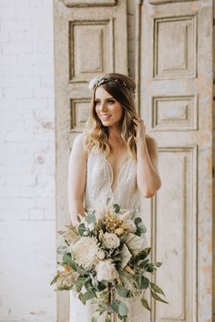 a woman in a wedding dress holding a bridal bouquet