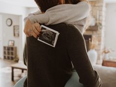 a man and woman hug in the living room