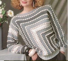 a woman is posing for a photo wearing a sweater