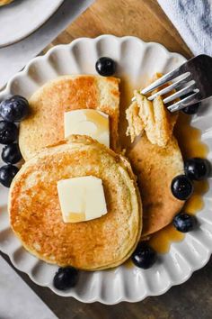 pancakes with butter and blueberries on a plate