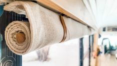 a roll of fabric hanging from the side of a window