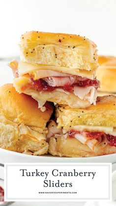 turkey cranberry sliders stacked on top of each other in a white plate