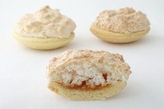 three small pastries with powdered sugar on them