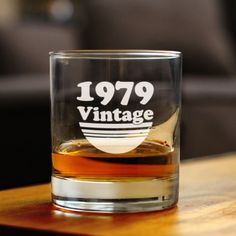 an old fashioned glass sitting on top of a wooden table