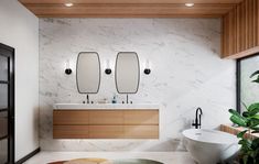 a modern bathroom with two sinks and large mirrors on the wall, along with an oval rug