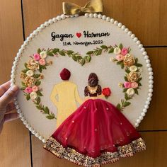 a handmade wedding ornament with a bride and groom on it's back