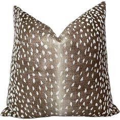 a brown pillow with white spots on it