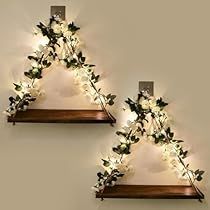 two wooden shelves with flowers on them and lights in the shape of triangle shaped letters