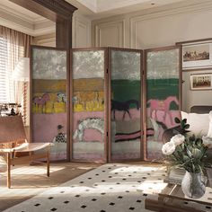 a room divider in the middle of a living room filled with furniture and flowers