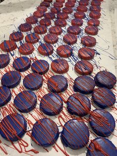 red and blue decorated cookies sitting on top of a table