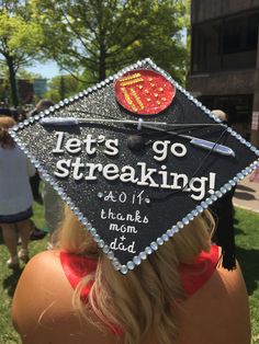 a woman wearing a graduation cap that says let's go freaking