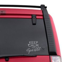 a red car with the words keep calm and sparkle written on it's side