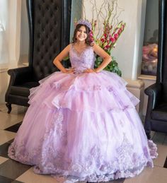 a woman in a purple dress posing for the camera