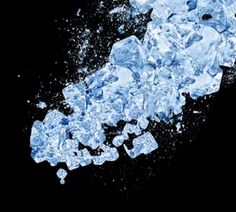 ice cubes are scattered around on a black background