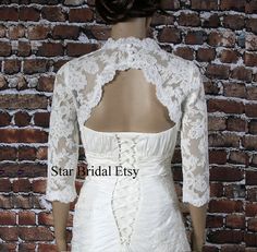 the back of a wedding dress with lace on it