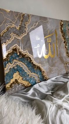 an image of a bed with white fur on the floor and gold foiled sheets