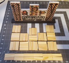 cut out pieces of wood sitting on top of a cutting board with the words happy thanksgiving