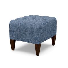 a blue foot stool with wooden legs on an isolated white background for use in interior and exterior design