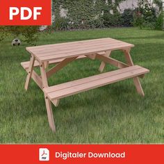 a wooden picnic table sitting in the grass next to a soccer ball on top of it