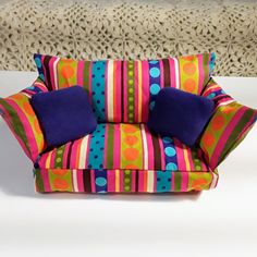 a colorful couch sitting on top of a white table